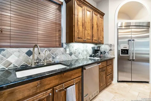 a kitchen with granite countertop cabinets and window