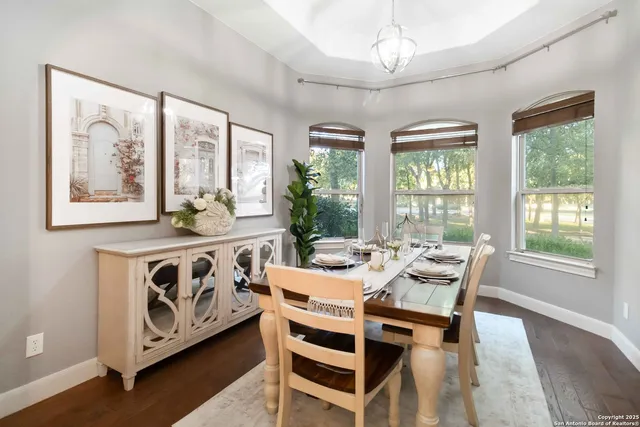 a view of a dining room with furniture and wooden floor