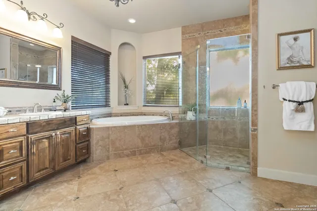a bathroom with a granite countertop toilet sink and mirror