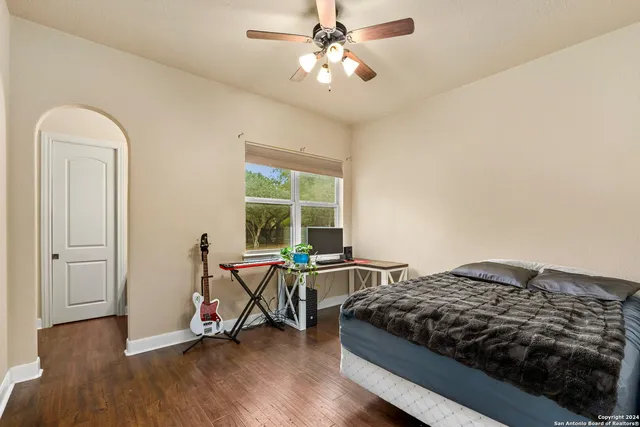 a front view of a house with a garden and trees
