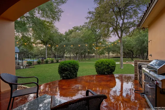 an aerial view of a houses with a yard