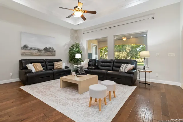 a living room with furniture potted plant and a chandelier