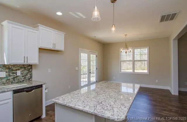 a view of kitchen island wooden floor windows and living room