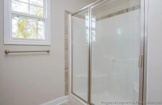 a bathroom with a glass shower door