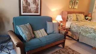 3727 South Atlantic Avenue, Unit 3150 Daytona Beach, FL 32118 - Photo 11 of 39 a living room with furniture and a window