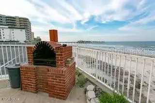 a view of a terrace with lawn chairs