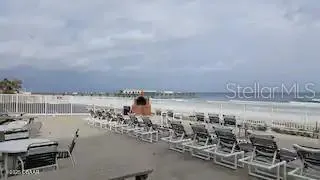 a view of swimming pool with outdoor seating and city view