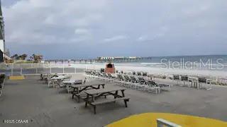 3727 South Atlantic Avenue, Unit 3150 Daytona Beach, FL 32118 - Photo 22 of 39 a view of swimming pool with outdoor seating and city view