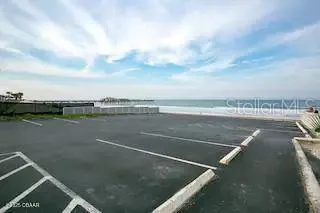 a view of an empty room with kitchen