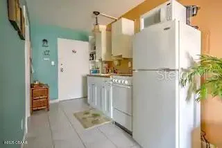 a utility room with cabinets and glass door