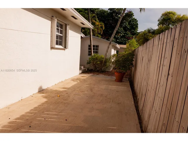 a view of a backyard with wooden fence