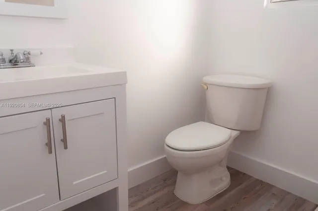 a bathroom with a toilet sink and shower