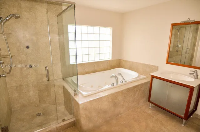 a bath tub sitting next to a bathroom sink