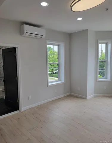 an empty room with windows and closet