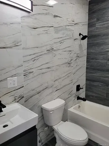 a white toilet sitting next to a bathroom sink