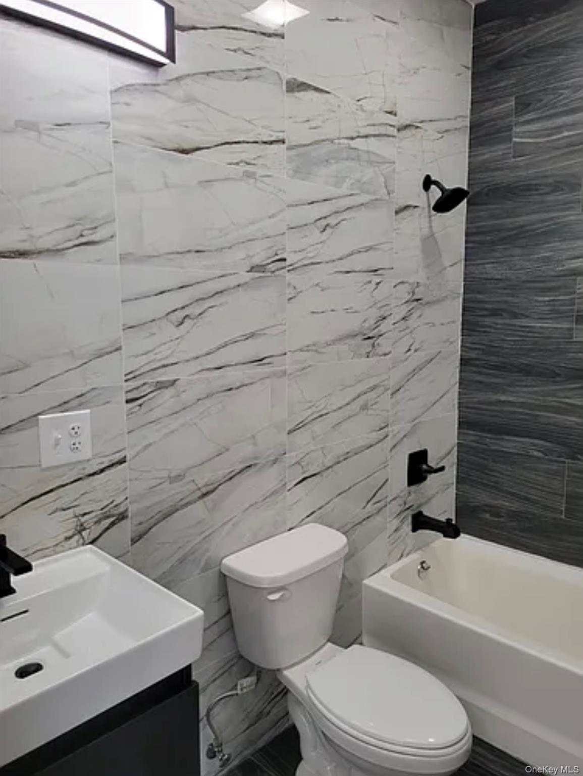 58 Smith Street, Unit 3A Poughkeepsie, NY 12601 - Photo 12 of 16 a white toilet sitting next to a bathroom sink