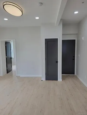 an empty room with closet and a bathroom