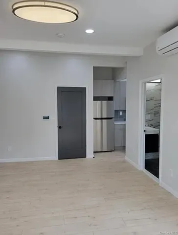 a view of empty room with kitchen
