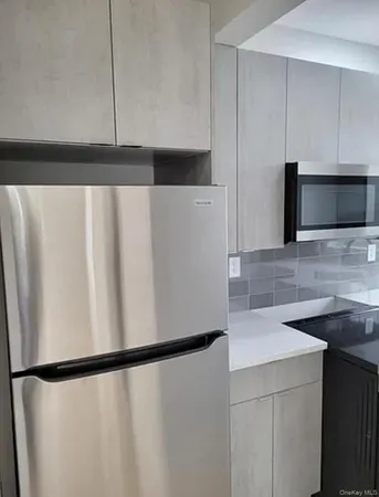 a view of a kitchen with a sink and cabinets