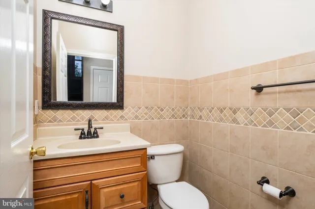 a bathroom with a toilet a sink and mirror