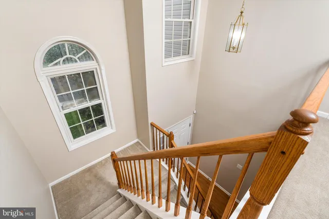 a view of staircase with railing and windows