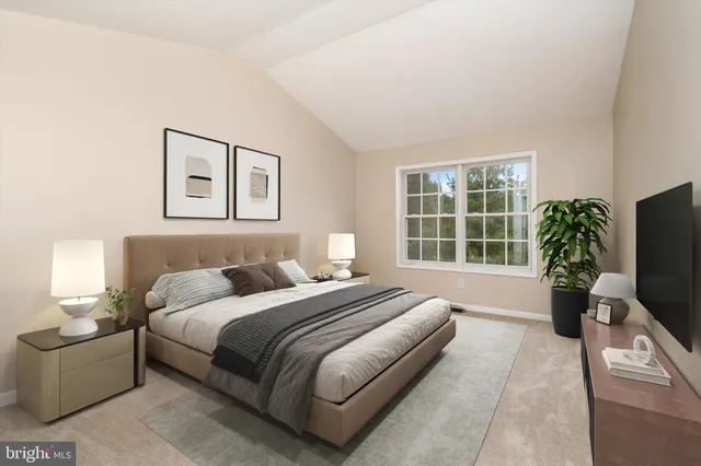 a spacious bedroom with a bed and a potted plant