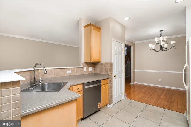 a bathroom with a granite countertop sink a toilet a mirror and bathtub