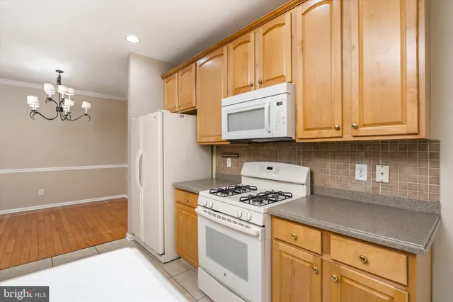 a kitchen with stainless steel appliances white cabinets and a stove top oven