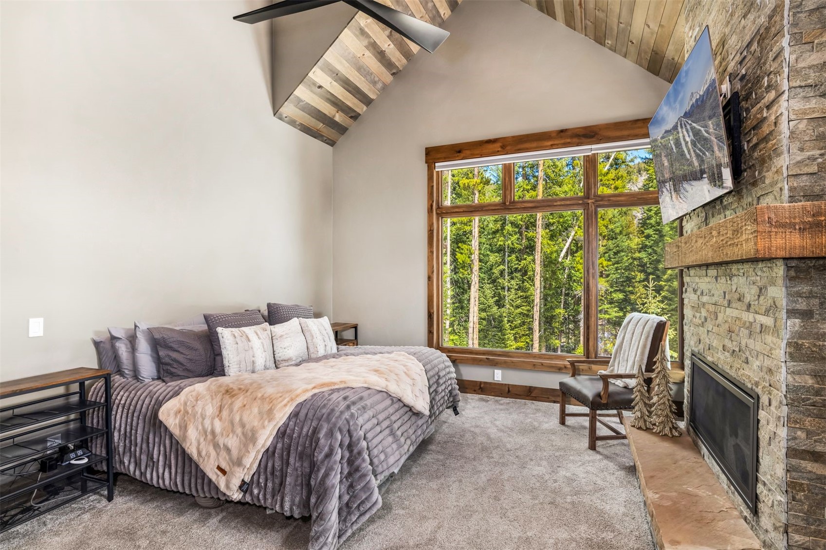 99 Independence Lane Keystone, CO 80435 - Photo 17 of 50 a spacious bedroom with a bed and a fireplace