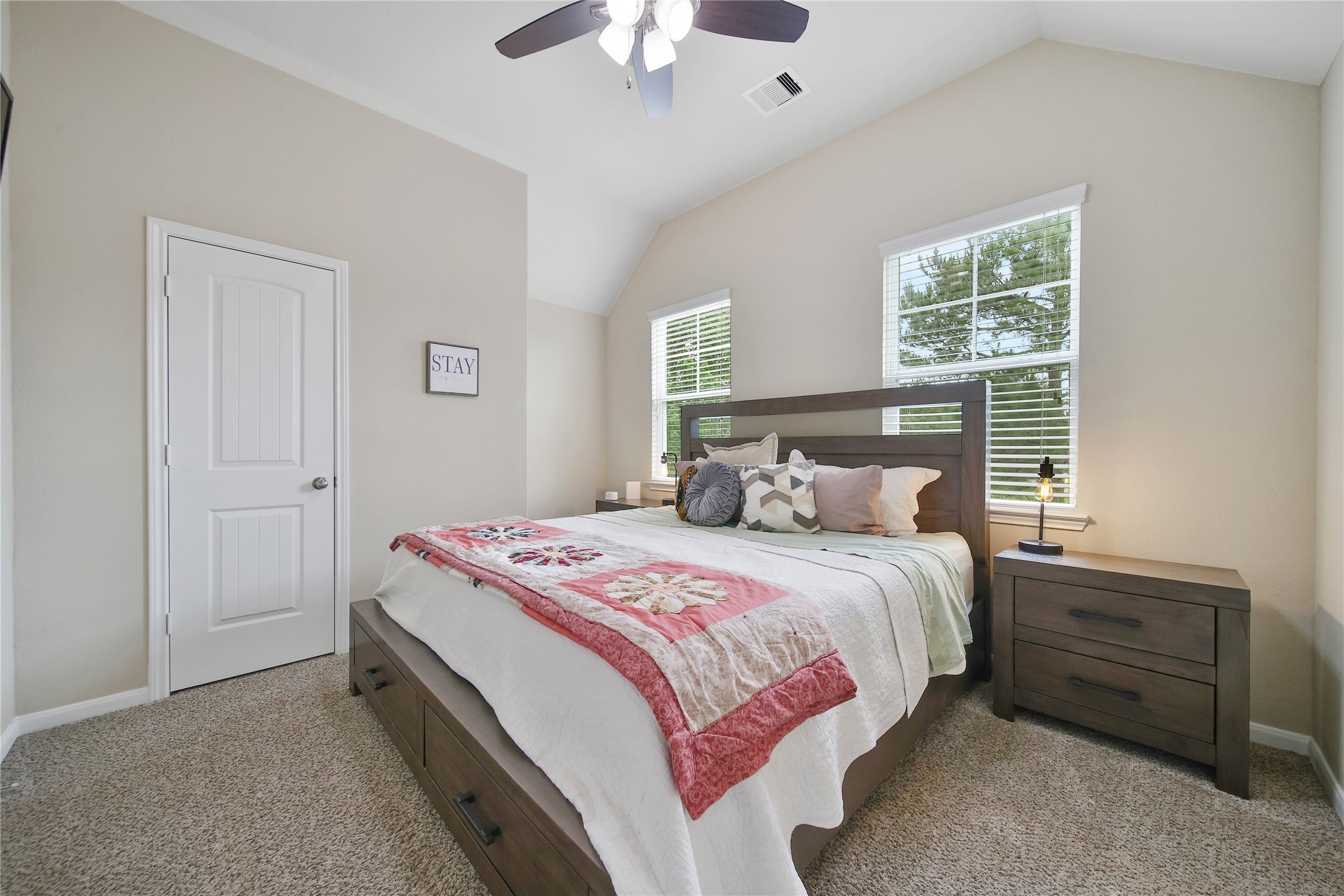 9223 Wapiti Trail Conroe, TX 77303 - Photo 33 of 45 a bedroom with a bed and a chandelier