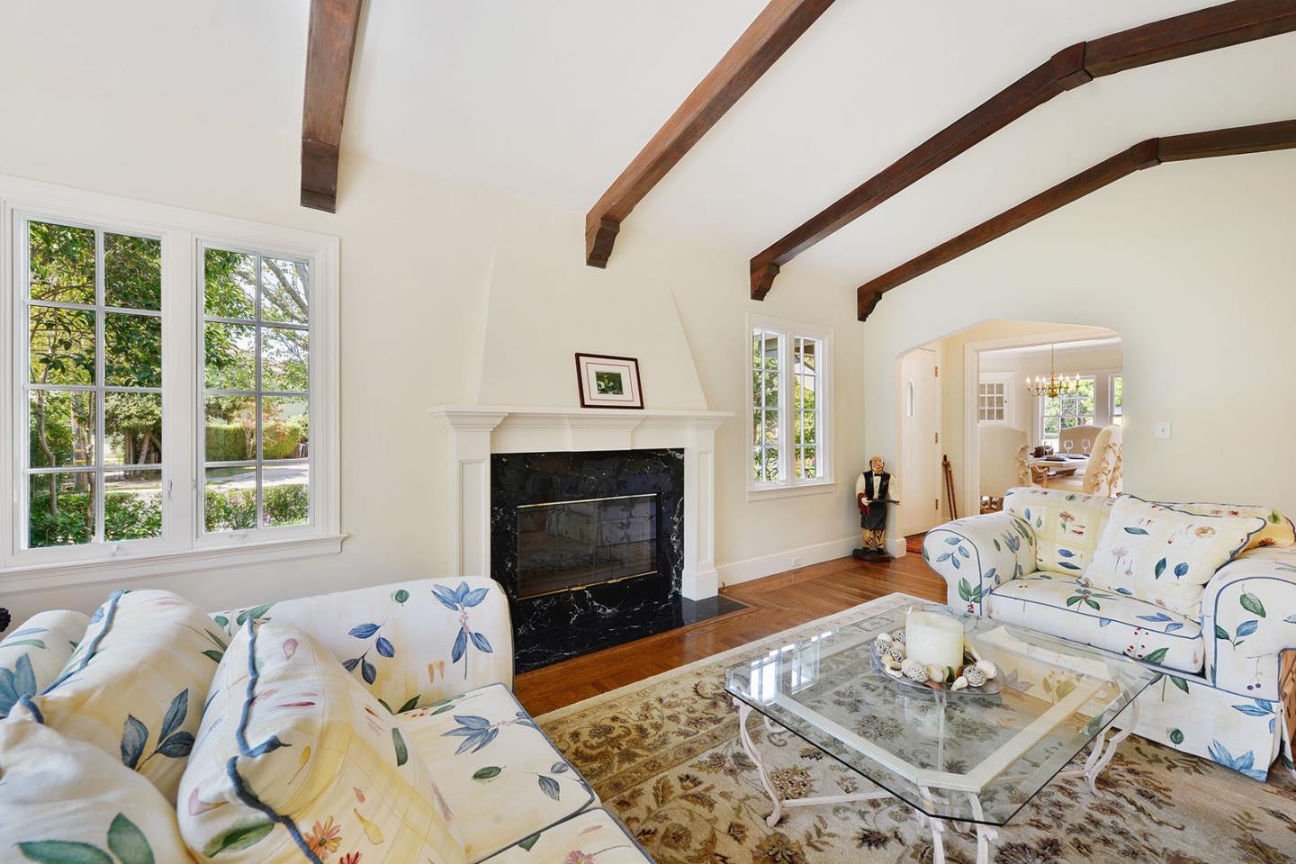181 Warren Road San Mateo, CA 94401 - Photo 16 of 49 a living room with furniture a fireplace and a floor to ceiling window