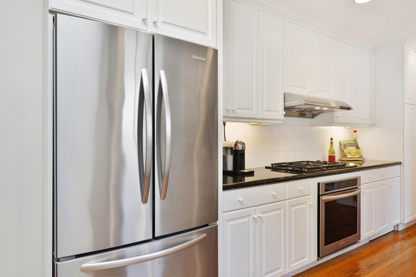181 Warren Road San Mateo, CA 94401 - Photo 21 of 49 a kitchen with stainless steel appliances granite countertop a refrigerator and a stove