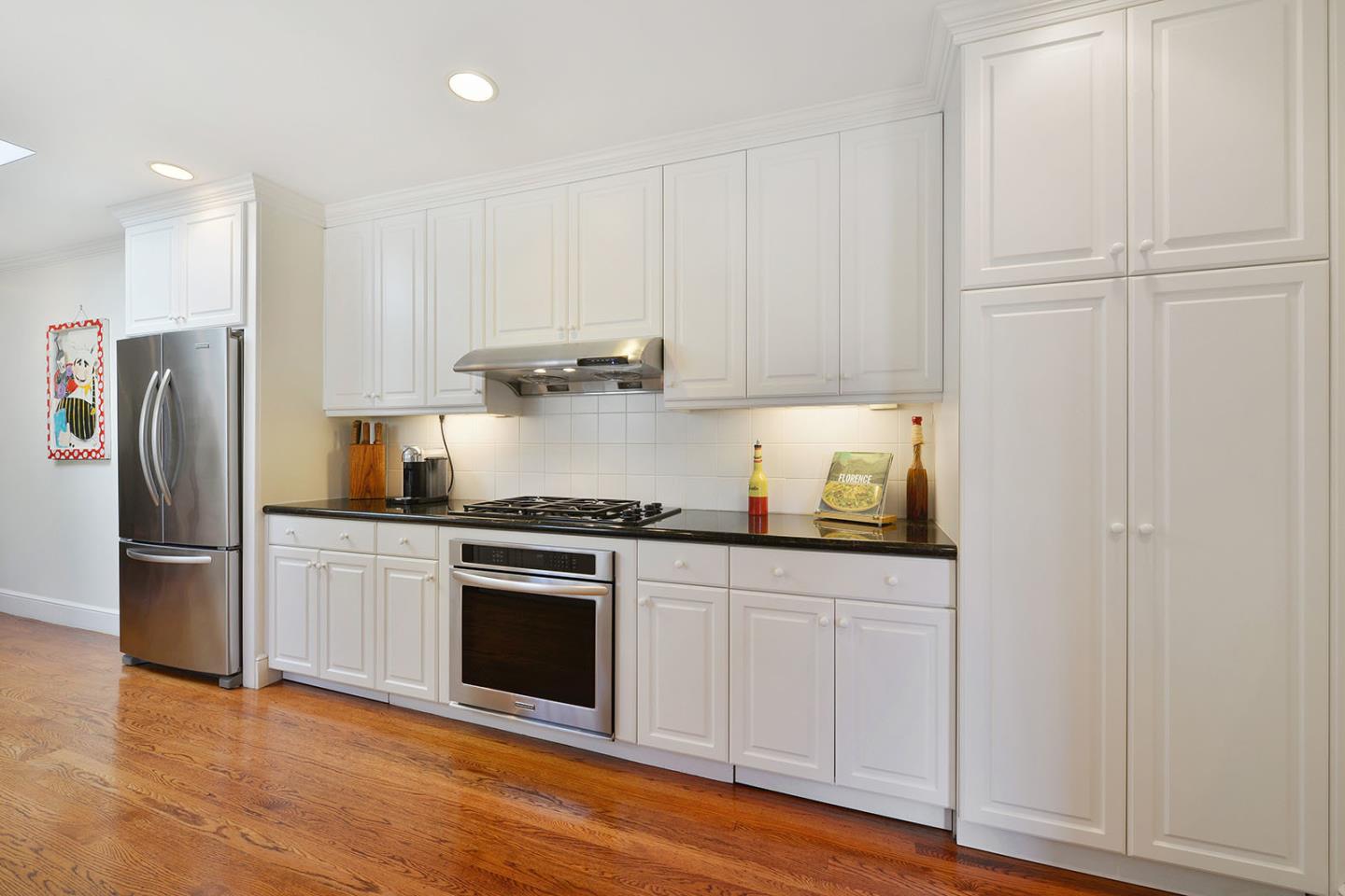 181 Warren Road San Mateo, CA 94401 - Photo 22 of 49 a kitchen with stainless steel appliances granite countertop a refrigerator and a stove top oven