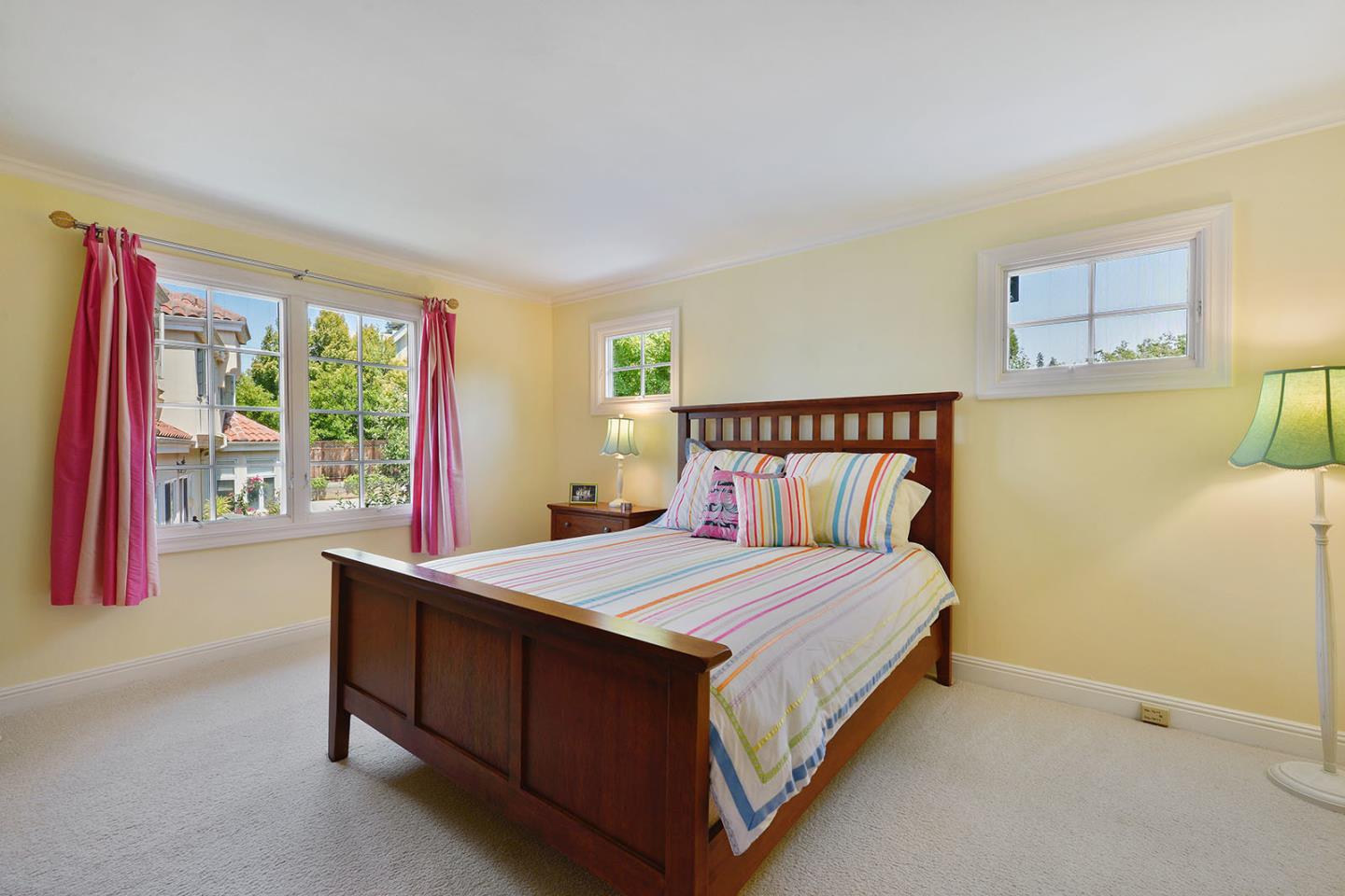 181 Warren Road San Mateo, CA 94401 - Photo 41 of 49 a bedroom with a bed lamp and a window