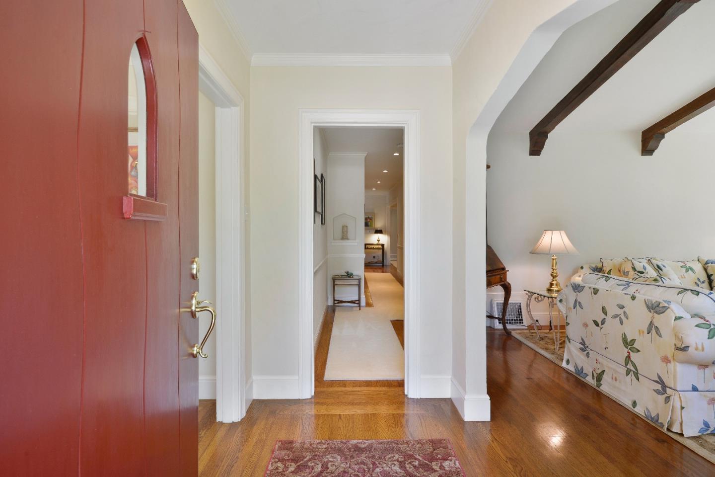 181 Warren Road San Mateo, CA 94401 - Photo 8 of 49 a view of a hallway with wooden floor and dining room