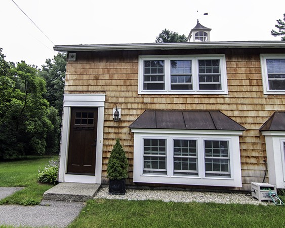 16 Radcliffe Road, Unit LEFT Billerica, MA 01821 - Photo 1 of 12 a front view of a house with a garden