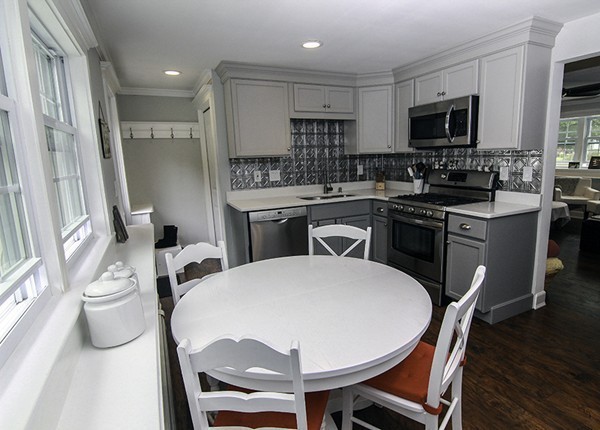 16 Radcliffe Road, Unit LEFT Billerica, MA 01821 - Photo 5 of 12 a kitchen with stainless steel appliances a dining table chairs microwave and sink