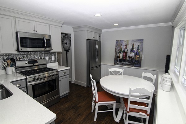 16 Radcliffe Road, Unit LEFT Billerica, MA 01821 - Photo 6 of 12 a kitchen with stainless steel appliances a stove a sink and a refrigerator