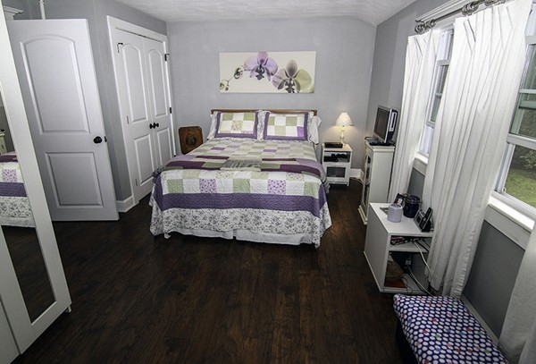 16 Radcliffe Road, Unit LEFT Billerica, MA 01821 - Photo 8 of 12 a bedroom with wooden floor and a bed