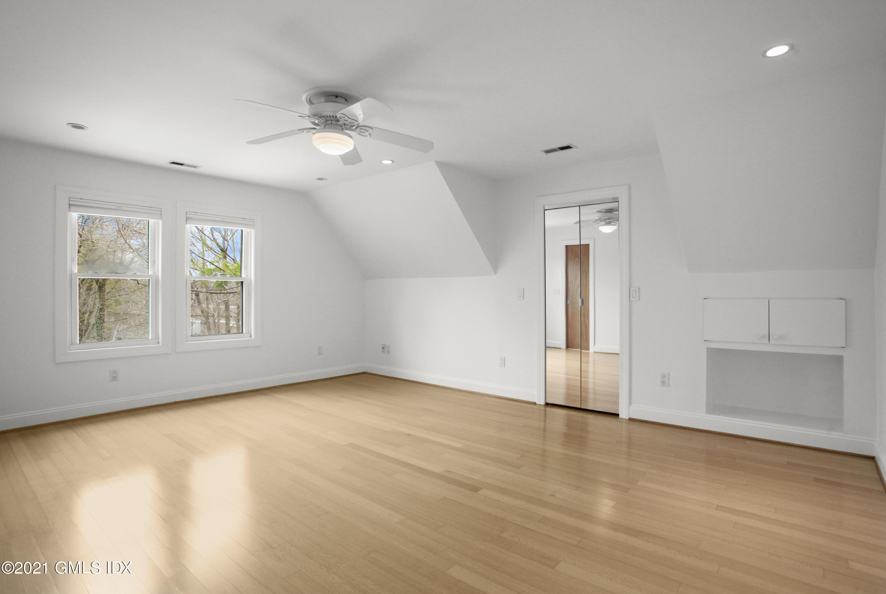 52 Bruce Park Drive, Unit B Greenwich, CT 06830 - Photo 13 of 20 wooden floor in an empty room with a window