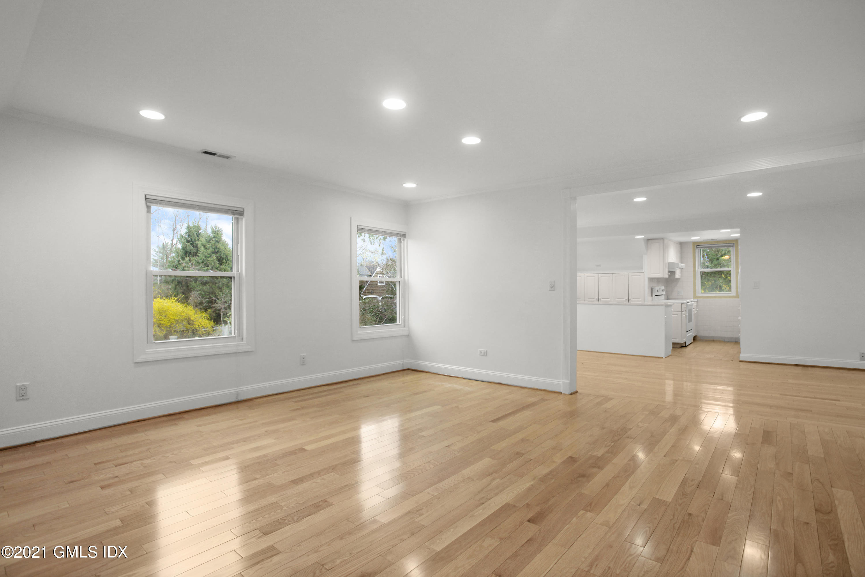 52 Bruce Park Drive, Unit B Greenwich, CT 06830 - Photo 8 of 20 a view of empty room with wooden floor and windows
