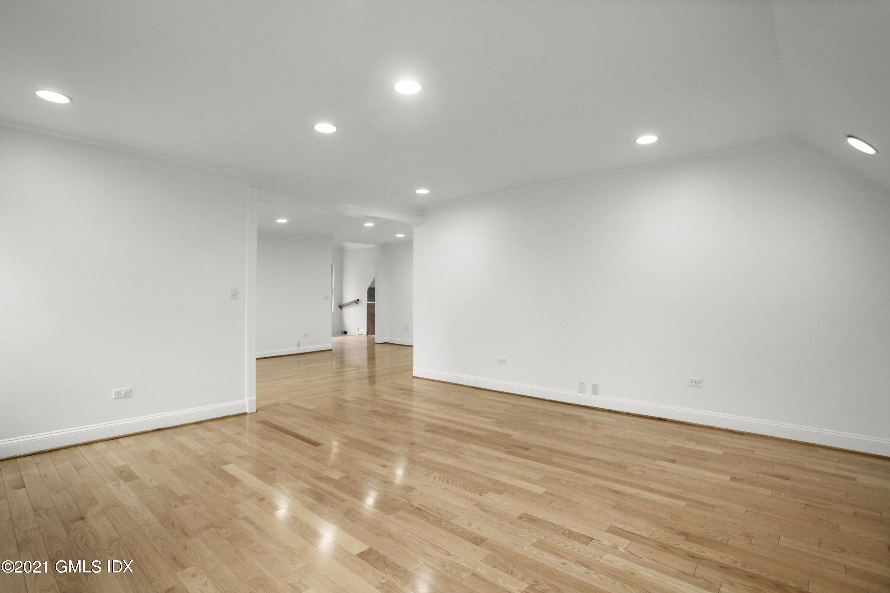 52 Bruce Park Drive, Unit B Greenwich, CT 06830 - Photo 9 of 20 an empty room with wooden floor and windows