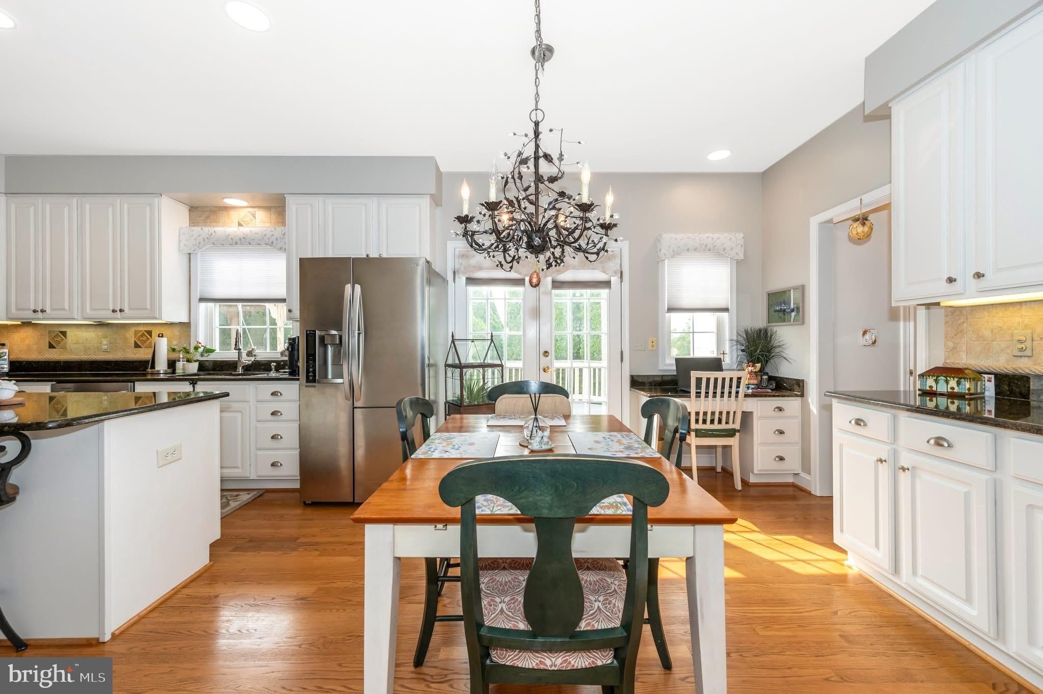 1280 St Michaels Road Mount Airy, MD 21771 - Photo 23 of 43 a kitchen with refrigerator cabinets dining table and chairs