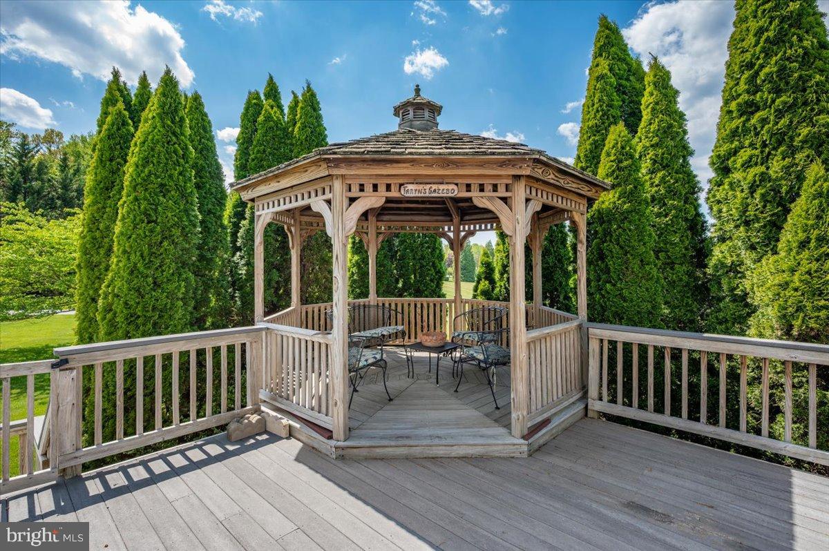 1280 St Michaels Road Mount Airy, MD 21771 - Photo 32 of 43 a view of a deck with a table and chairs with wooden floor