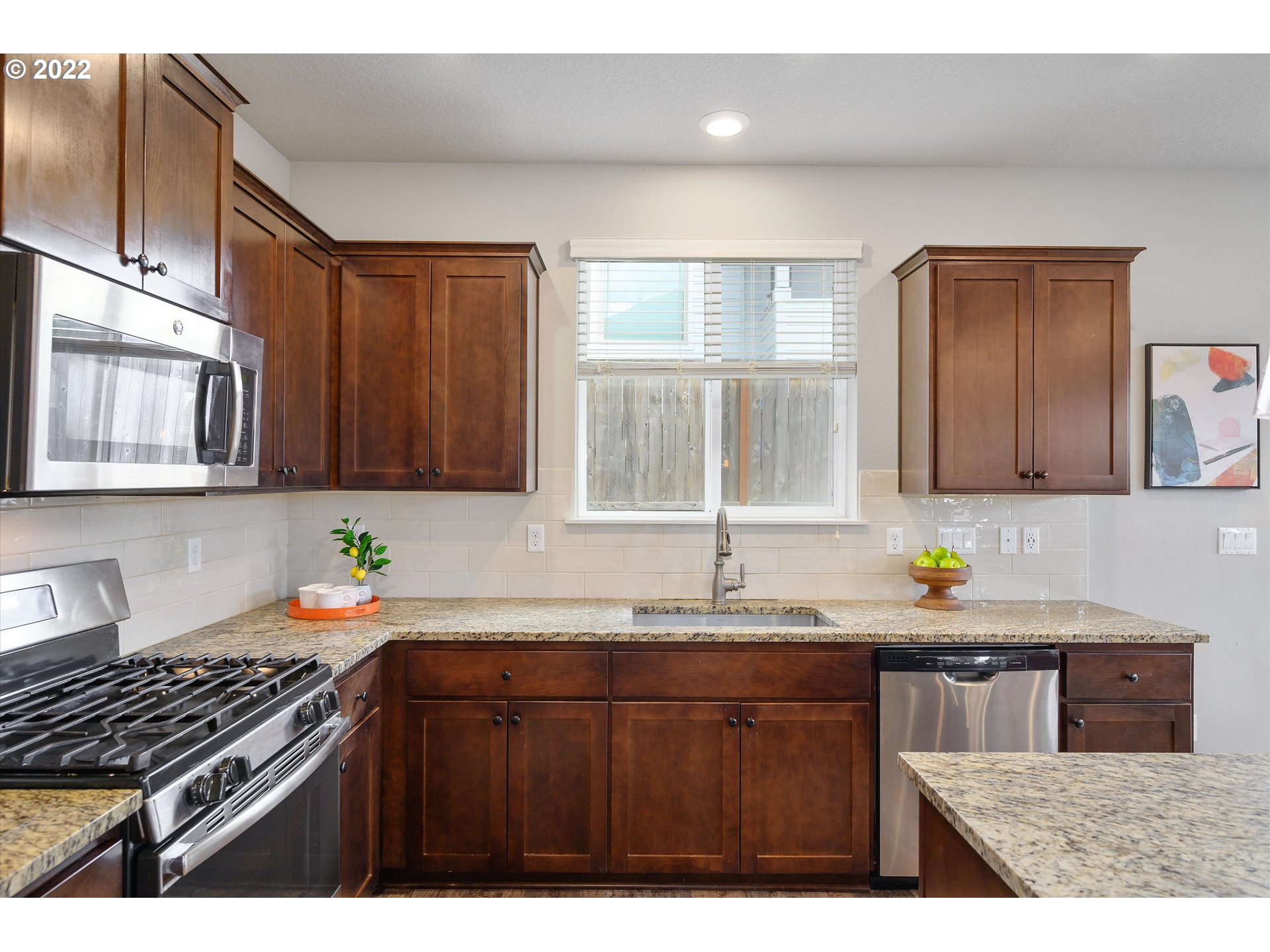 4288 Southwest Redfern Avenue Gresham, OR 97080 - Photo 11 of 32 a kitchen with granite countertop a sink stove and cabinets