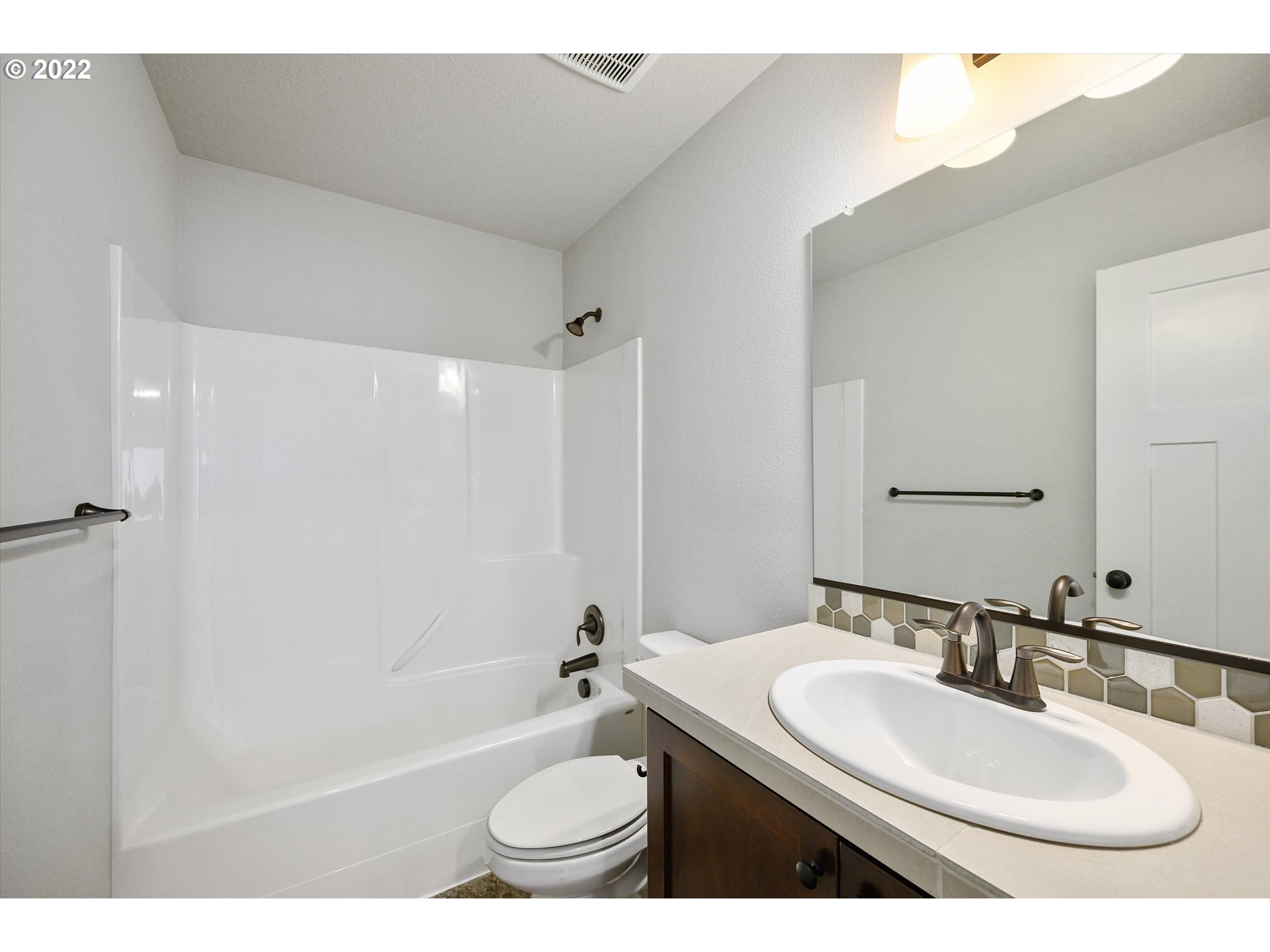 4288 Southwest Redfern Avenue Gresham, OR 97080 - Photo 25 of 32 a bathroom with a sink a toilet and a bathtub