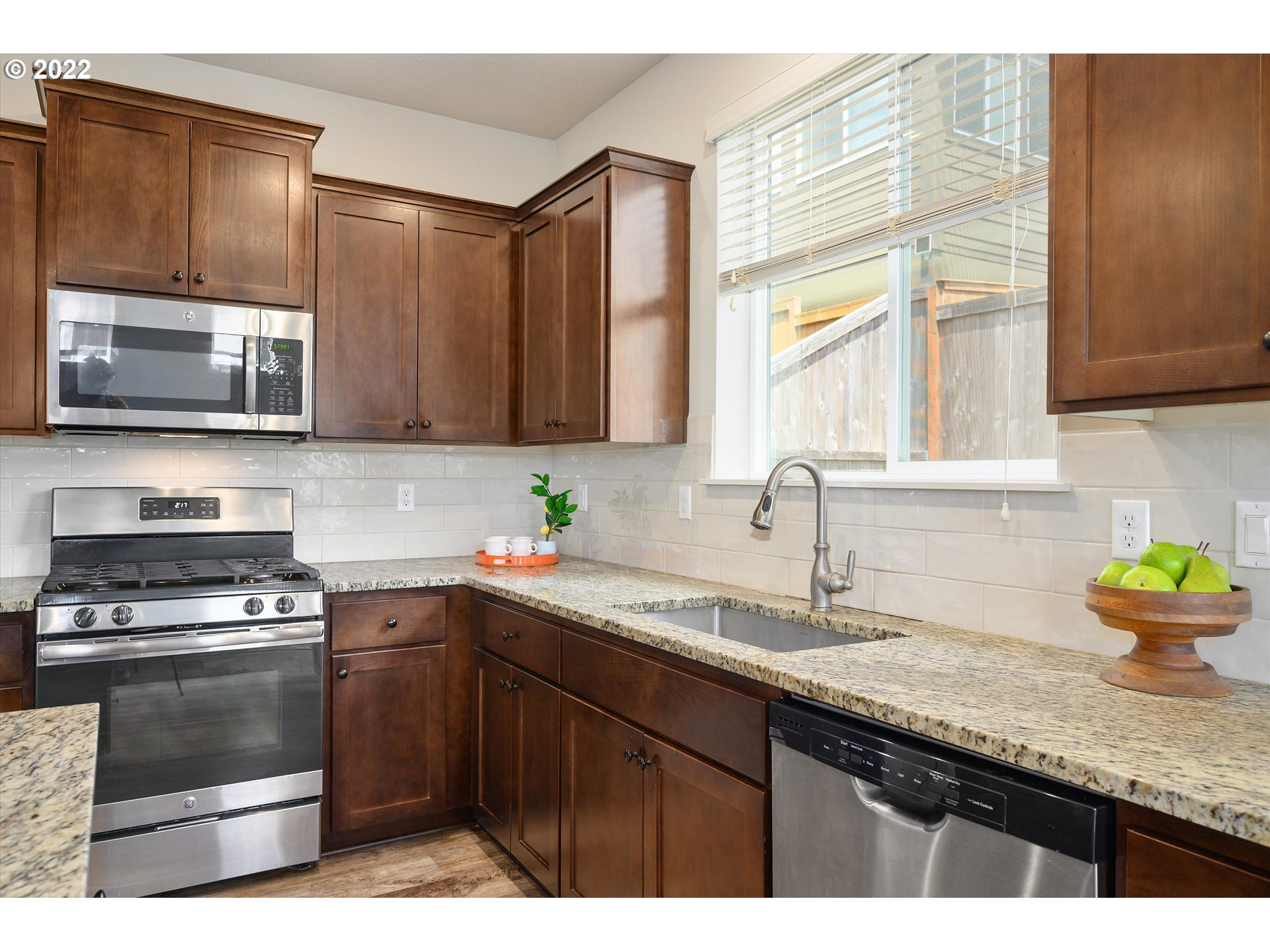 4288 Southwest Redfern Avenue Gresham, OR 97080 - Photo 10 of 32 a kitchen with granite countertop cabinets stainless steel appliances and a sink