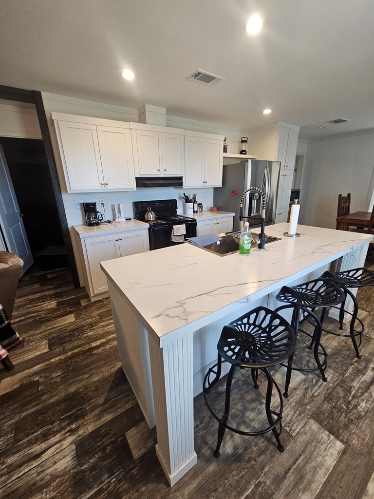 Lot 1 Rr 674 Rocksprings, TX 78880 - Photo 12 of 16 a kitchen with a table chairs stove and refrigerator