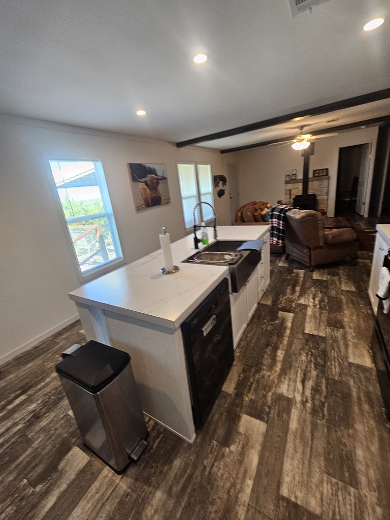 Lot 1 Rr 674 Rocksprings, TX 78880 - Photo 14 of 16 a kitchen with sink a stove and chairs with wooden floor