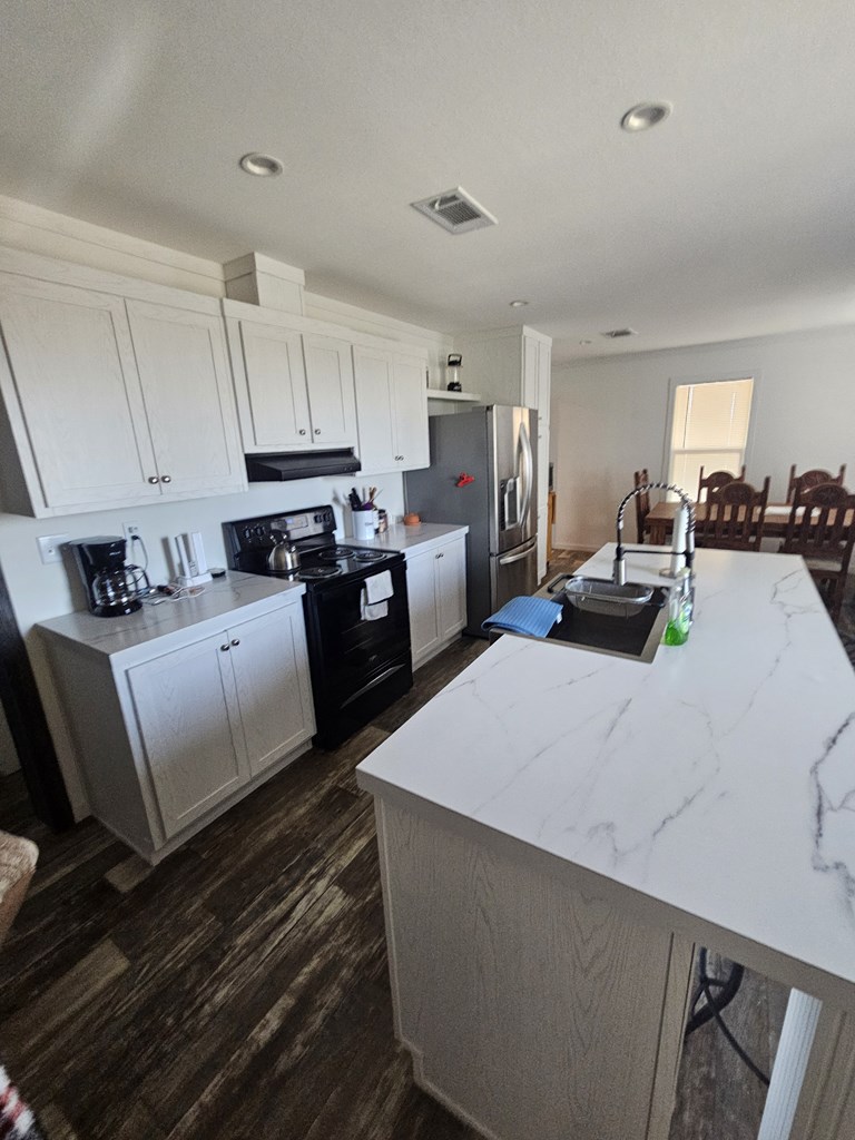 Lot 1 Rr 674 Rocksprings, TX 78880 - Photo 9 of 16 a kitchen with cabinets a sink and white appliances
